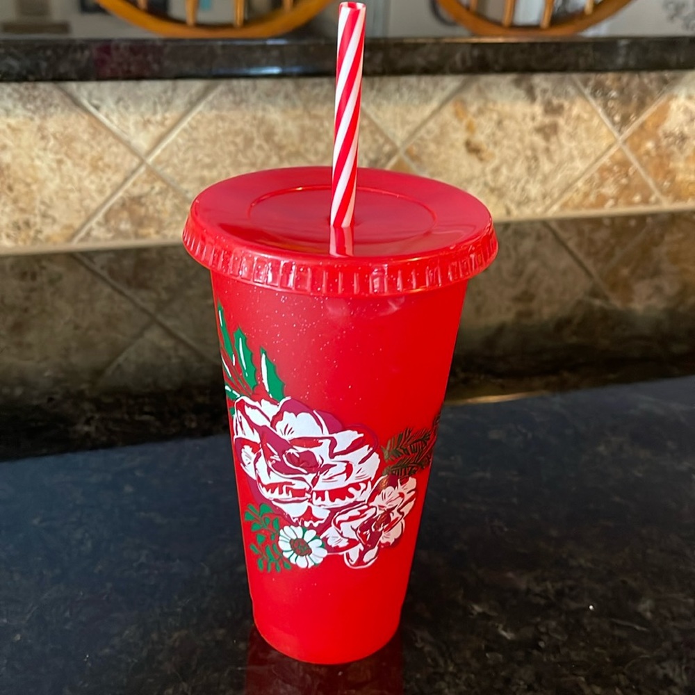 Starbucks red cold beverage cup with straw.